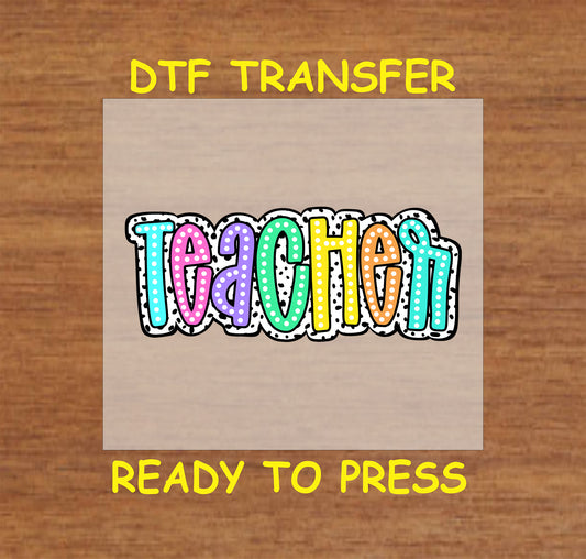 Teacher DTF transfer with colorful polka dot letters and bold black outline.