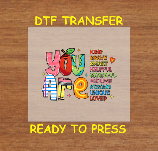 DTF transfer with colorful "You Are" text and affirmations like kind, brave, smart, loved.