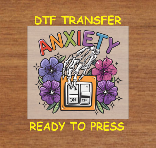 DTF transfer with skeleton hand flipping on switch under the word Anxiety and surrounded by flowers.
