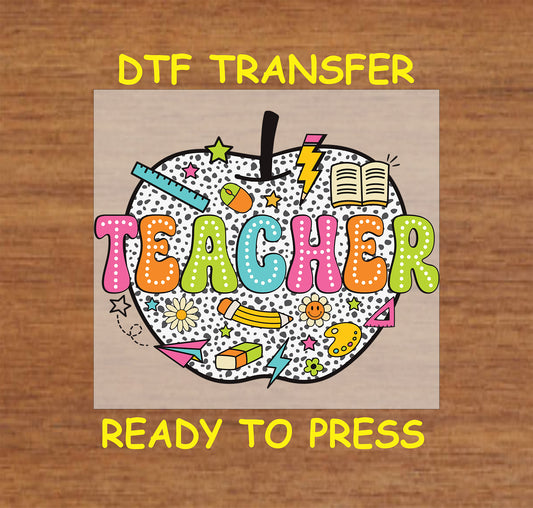 Colorful teacher DTF transfer with polka dot apple and school supplies like pencil and book.