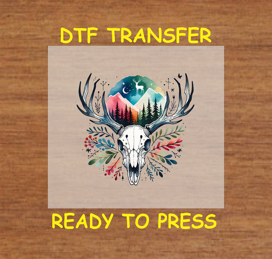 Deer skull DTF transfer with antlers, floral accents, mountain scene, trees, and stars.