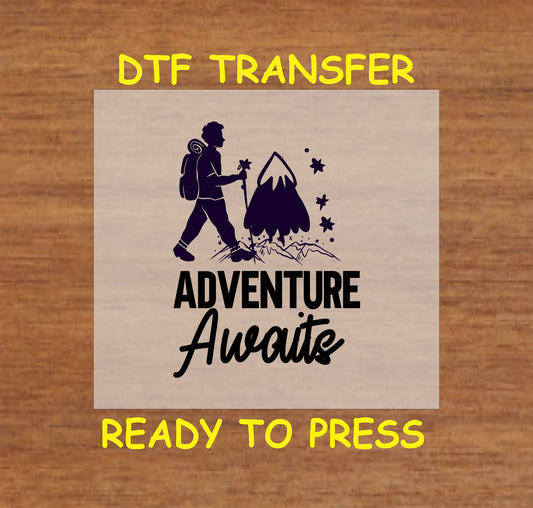 Hiker silhouette with mountain and stars and text saying Adventure Awaits, DTF transfer.