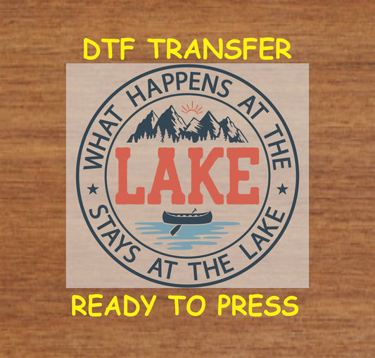DTF transfer with What Happens at the Lake quote, canoe, water, sun, and mountain artwork.