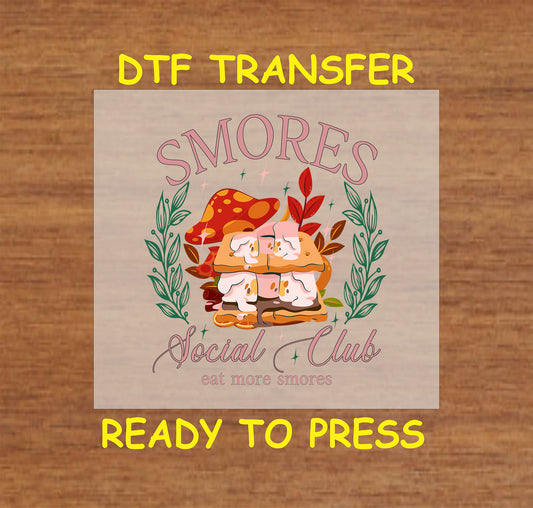 S’mores Social Club DTF transfer with mushrooms, leaves, and cartoon marshmallows.