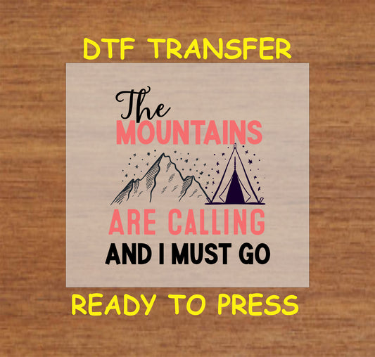 DTF transfer with mountains, tent, and the phrase "The Mountains Are Calling And I Must Go"