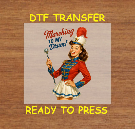 Retro majorette in red, white, and blue outfit holding baton with Marching to My Drum text.