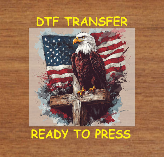 DTF transfer with bald eagle on wooden cross and American flag background.
