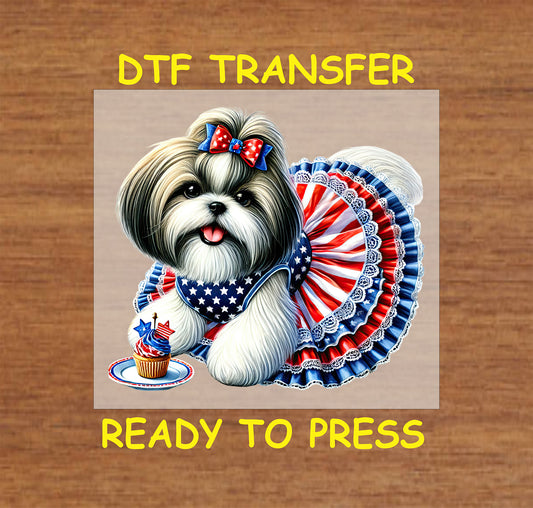 Shih Tzu in patriotic dress with cupcake and bow.