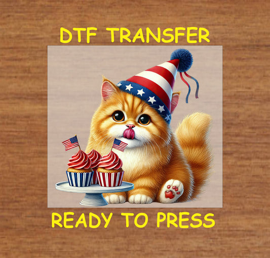 Orange kitten in patriotic party hat with cupcakes and American flags.