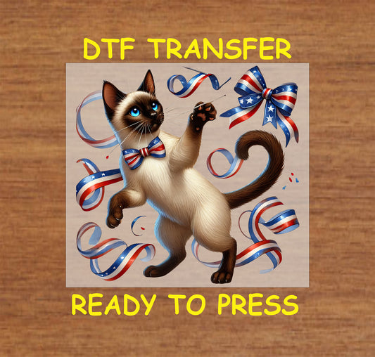 Siamese cat playing with red white blue ribbons and wearing a patriotic bowtie DTF transfer.