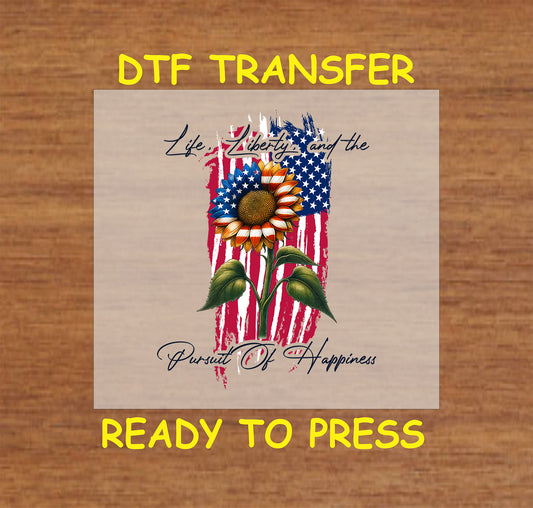 Patriotic sunflower with red white blue petals over grunge flag and Life Liberty Happiness text.