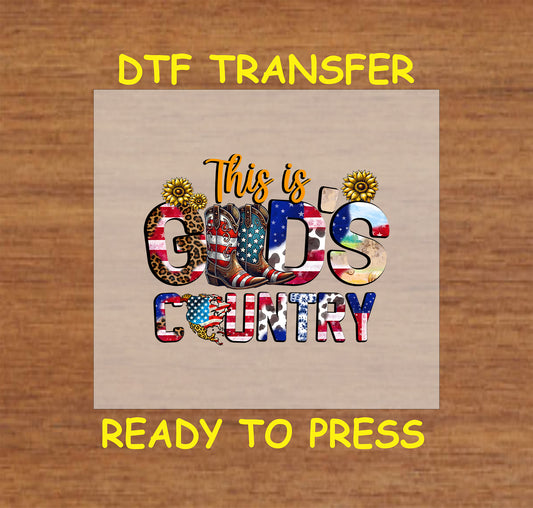 This is God’s Country DTF transfer with cowboy boots, sunflowers, and red white blue letters.