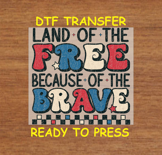 Red, white, and blue distressed text reading Land of the Free Because of the Brave DTF transfer.
