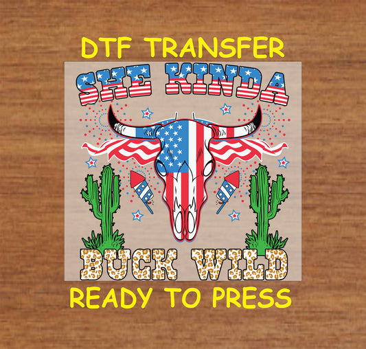 DTF transfer with patriotic cow skull, fireworks, stars, cacti, and She Kinda Buck Wild text.