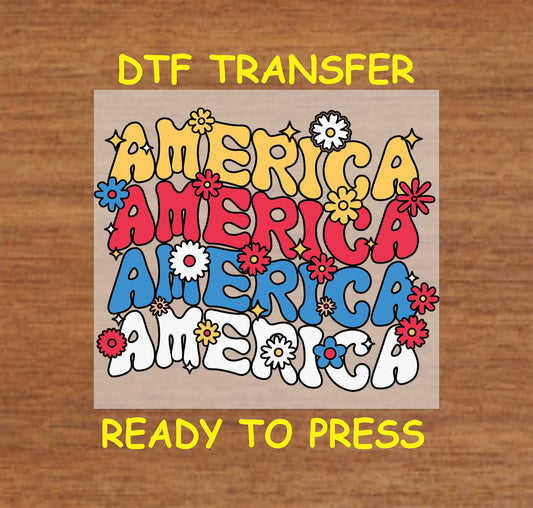 DTF transfer with stacked America text in red, blue, yellow, and white with floral accents.
