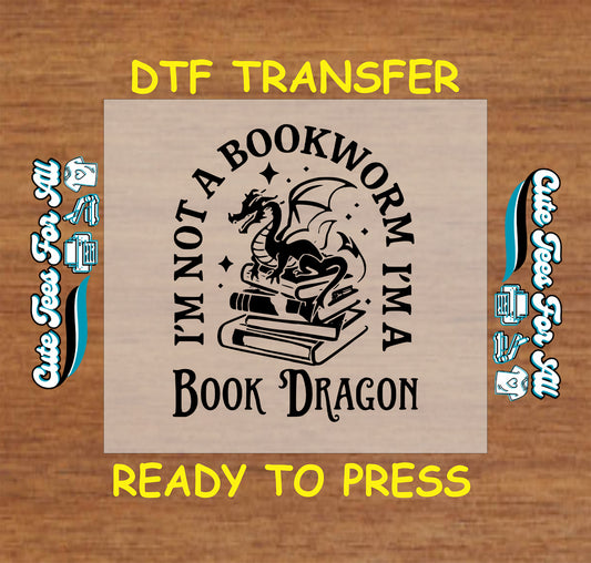 Dragon sitting on books with text "I'm Not a Bookworm I'm a Book Dragon" in black.