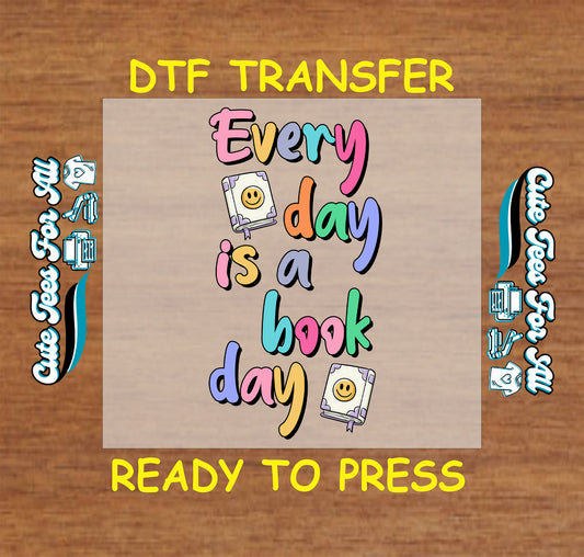 Colorful DTF transfer with the phrase “Every Day is a Book Day” and smiley books.