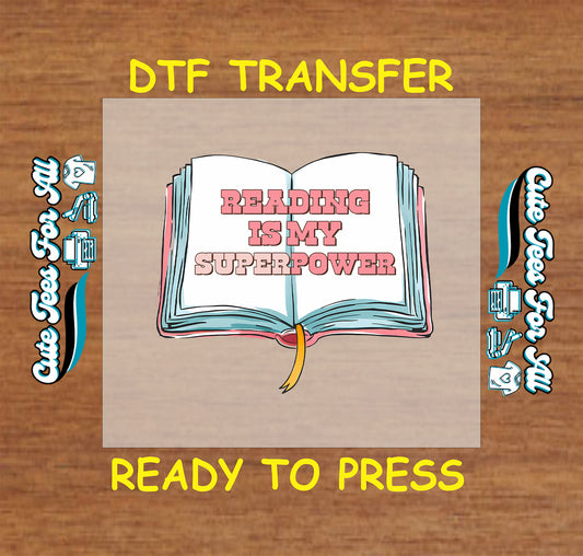 Open book with the phrase “Reading Is My Superpower” in pink letters.