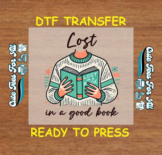 DTF transfer showing a headless person holding a book with text “Lost in a good book”