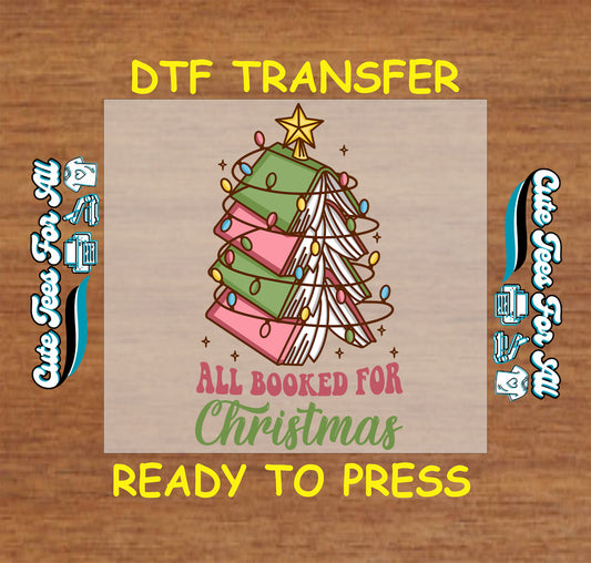 DTF transfer of Christmas tree made of books with lights and “All Booked for Christmas” quote.
