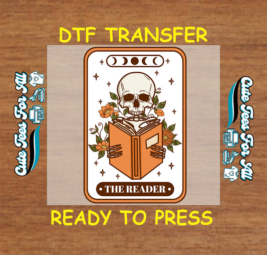 DTF transfer of a tarot-style skull holding a book with floral details and “The Reader” label.