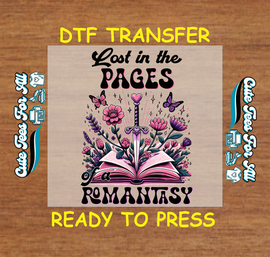 DTF transfer of an open book with sword, pink flowers, and text “Lost in the Pages of a Romantasy”