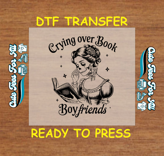 Black and white skeleton woman crying while reading a book DTF transfer.