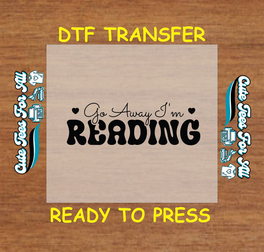 Text reading “Go Away I’m Reading” in bold playful letters with hearts.