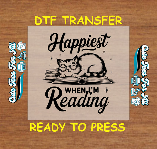 Black DTF transfer with a cat in glasses laying on books and the phrase “Happiest When I’m Reading”