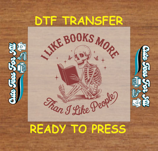 DTF transfer with skeleton reading a book and text saying “I Like Books More Than I Like People”