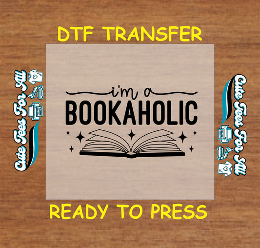 Open book with sparkles and text that says “I'm a Bookaholic” in bold font.