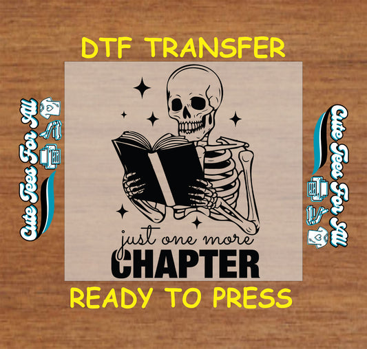 Skeleton reading a book with text “Just One More Chapter” and sparkles around.