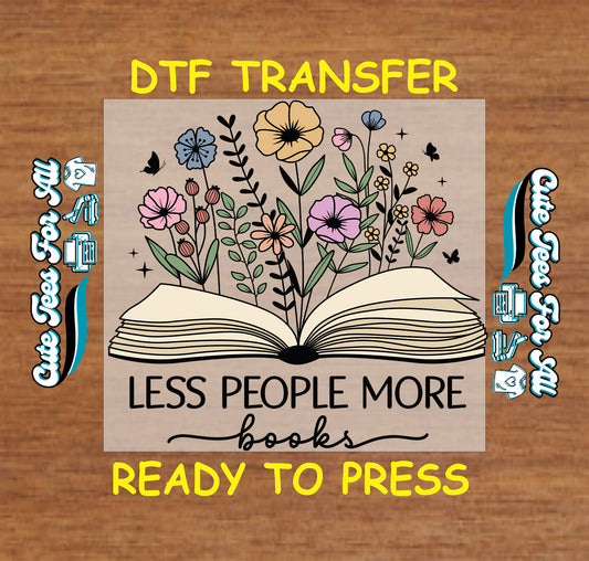 DTF transfer of open book with colorful flowers and butterflies and the text “Less People More Books”