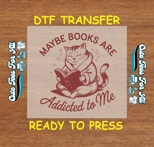 DTF transfer with cat in sweater reading a book and text “Maybe Books Are Addicted to Me”
