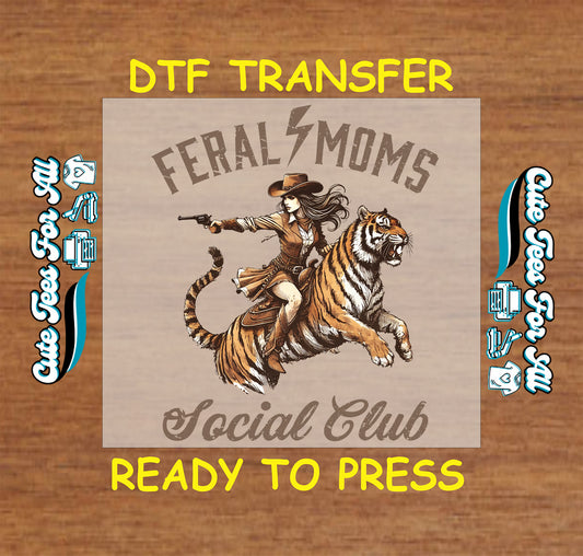 Cowgirl riding a tiger with gun drawn and “Feral Moms Social Club” text.
