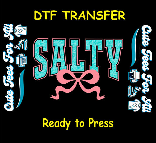 DTF transfer with SALTY text in teal palm pattern and pink bow on black background.