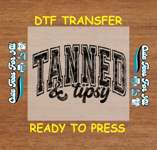 DTF transfer with distressed black Tanned and Tipsy text on light background.