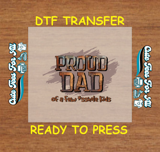 DTF transfer with “Proud Dad of a Few *sshole Kids” in rustic lettering.