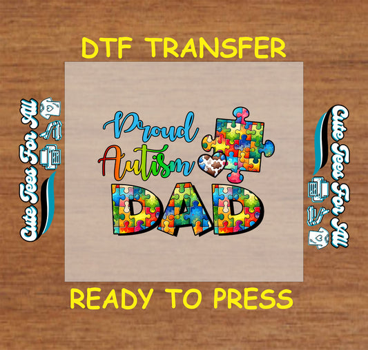 DTF transfer with Proud Autism Dad text in colorful puzzle pieces and heart accent.
