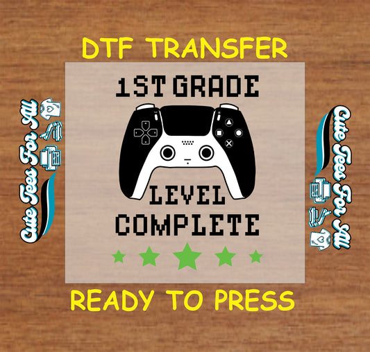 1st Grade Level Complete text with video game controller and green stars, DTF transfer ready to press.