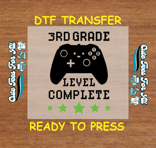 DTF transfer with 3rd Grade Level Complete and Xbox-style game controller.
