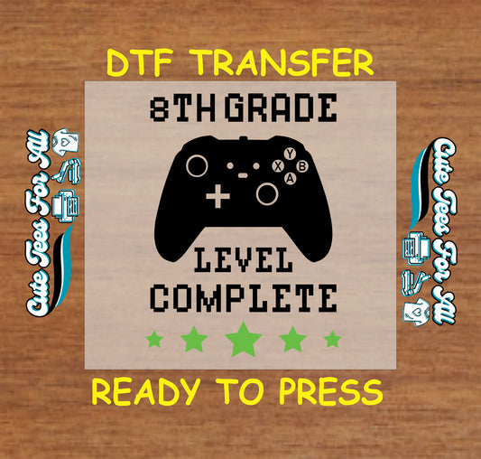 8th grade level complete DTF transfer with black game controller and green stars.