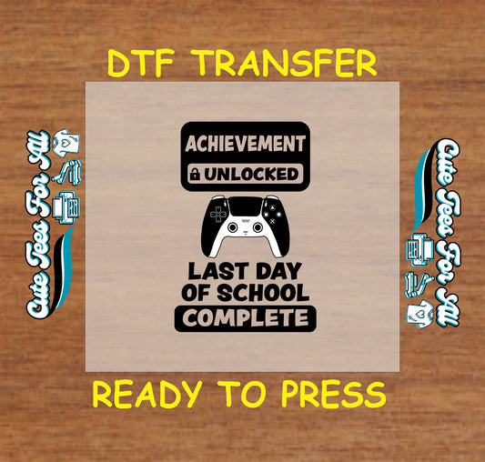DTF transfer with game controller and text “Achievement Unlocked Last Day of School Complete” in black.