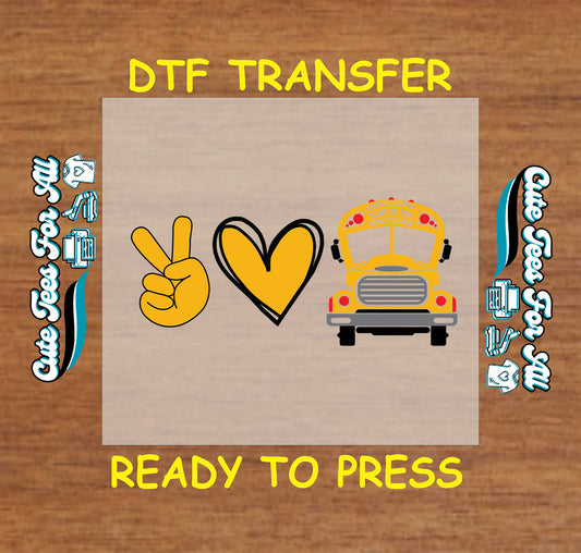 DTF transfer with yellow peace sign, yellow heart, and a full-color school bus graphic.
