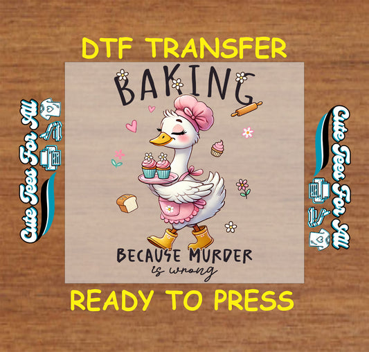 DTF transfer of duck in apron and chef hat holding cupcakes with text “Baking Because Murder Is Wrong”