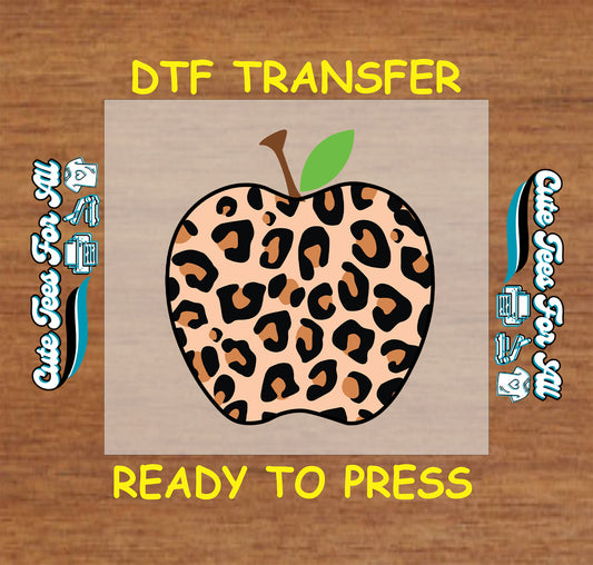Leopard print apple graphic for DTF transfer with green leaf and brown stem.