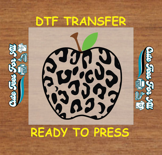 Black leopard print apple DTF transfer with brown stem and green leaf.