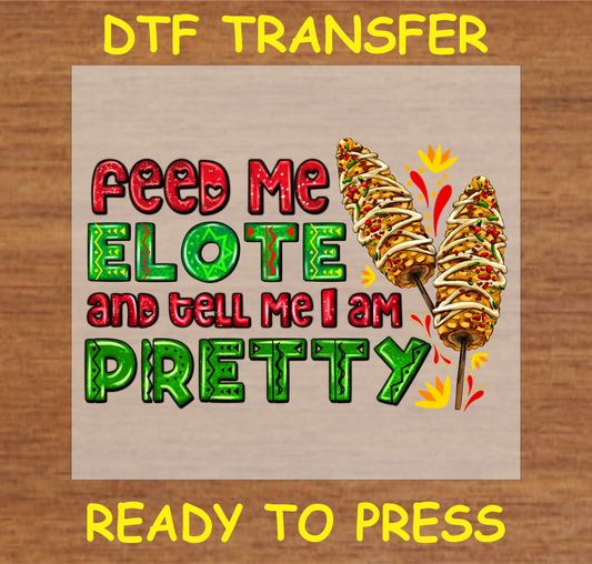  DTF transfer design featuring the text 'Feed Me Elote and Tell Me I'm Pretty' with illustrations of elote (Mexican street corn).