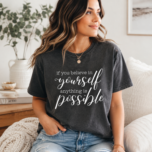 Woman wearing a t-shirt with an inspirational quote in a cozy living room.