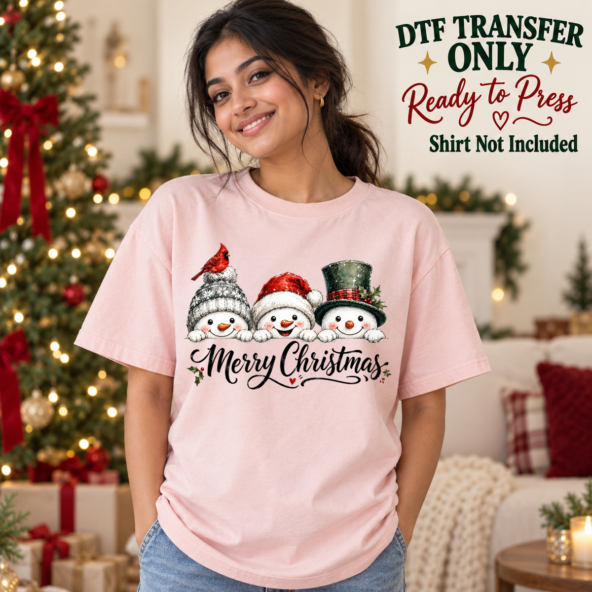 Christmas Snowman Trio design shown on a pink shirt worn by a model; DTF transfer only, shirt not included.